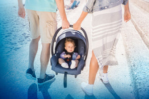 Parents carrying baby in Car Seat