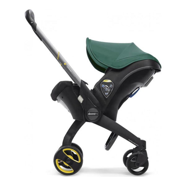 Doona car seat in stroller mode with green sun canopy